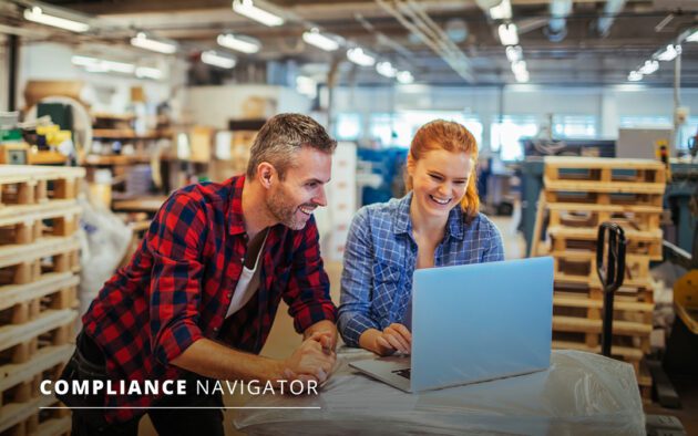 Man and woman in a shop looking at laptop