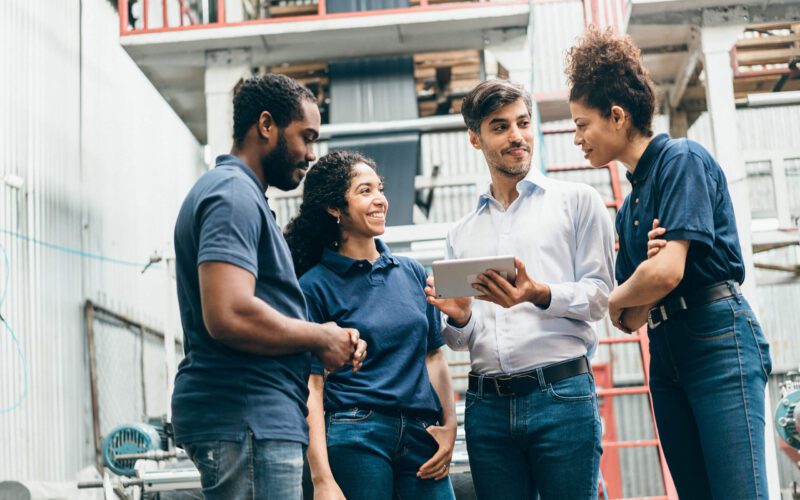 group of four employees reviewing time and attendance software