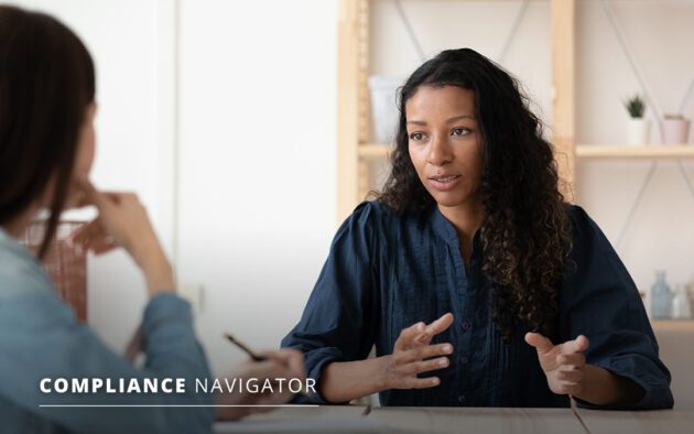 Women talking in an office with text saying "Compliance Navigator, October 2021"
