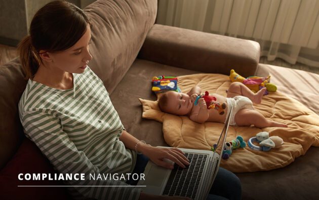 Woman sitting on a couch with a baby while she works on her laptop